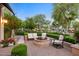 Outdoor patio with fire pit, comfortable seating, and lush landscaping at 9926 E Kemper Way, Scottsdale, AZ 85255
