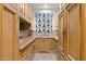 Well-appointed laundry room with ample storage and wood cabinets at 9926 E Kemper Way, Scottsdale, AZ 85255