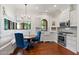 Charming kitchen nook with white cabinetry, granite counters, and a breakfast area at 9926 E Kemper Way, Scottsdale, AZ 85255