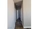 Long hallway with neutral colored walls at 1653 S 360Th Ave, Tonopah, AZ 85354