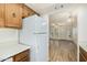 Kitchen with wood cabinets, white appliances, and view of living room at 3002 N 70Th St # 239, Scottsdale, AZ 85251