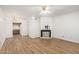 Living room with hardwood floors, fireplace, and kitchen view at 3002 N 70Th St # 239, Scottsdale, AZ 85251