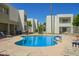 Community pool with lounge chairs and BBQ grills at 3002 N 70Th St # 239, Scottsdale, AZ 85251