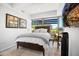 Bright bedroom with queen bed, wood furniture, and city views at 7117 E Rancho Vista Dr # 4011, Scottsdale, AZ 85251