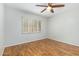 Bright bedroom featuring wood-look floors and a ceiling fan at 10511 N 104Th Pl, Scottsdale, AZ 85258