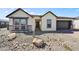 Cream-colored farmhouse style home with stone accents at 19003 W Lawrence Rd, Waddell, AZ 85355
