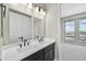 Bathroom with double vanity and large mirror at 19003 W Lawrence Rd, Waddell, AZ 85355