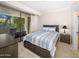 Bedroom with striped bedding and access to a private balcony at 7700 E Gainey Ranch Rd # 103, Scottsdale, AZ 85258