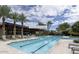 Resort-style pool with lounge chairs and palm trees at 7700 E Gainey Ranch Rd # 103, Scottsdale, AZ 85258
