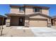 Two-story house with beige exterior and stone accents at 24668 W Alta Vista Rd, Buckeye, AZ 85326