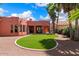 Landscaped backyard with artificial turf and covered patio at 886 W St Andrews Dr, Casa Grande, AZ 85122