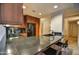 Modern kitchen with dark wood cabinets and granite countertops at 7141 E Rancho Vista Dr # 4007, Scottsdale, AZ 85251