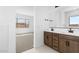 Double vanity bathroom with access to bedroom and walk-in closet at 37535 W Padilla St, Maricopa, AZ 85138