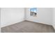 Cozy bedroom with neutral carpet and a window with natural light at 37535 W Padilla St, Maricopa, AZ 85138