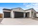 Two-car garage home with desert landscaping and a neutral color palette at 37535 W Padilla St, Maricopa, AZ 85138
