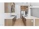 Modern kitchen with wood cabinets, quartz countertops, and stainless steel appliances at 37535 W Padilla St, Maricopa, AZ 85138