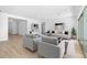 Open concept living room with neutral decor and access to patio at 37535 W Padilla St, Maricopa, AZ 85138