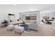 Spacious living room with large windows and access to the dining area at 37535 W Padilla St, Maricopa, AZ 85138