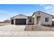 Two-car garage home with desert landscaping and a neutral color palette at 37535 W Padilla St, Maricopa, AZ 85138