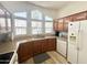 Clean and spacious kitchen with white appliances and wood cabinets at 241 S Aquamarine Dr, Apache Junction, AZ 85119