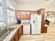 Kitchen boasts ample counter space, wood cabinets and white appliances at 241 S Aquamarine Dr, Apache Junction, AZ 85119