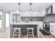Modern kitchen with white cabinets, gray herringbone backsplash, and stainless steel appliances at 8055 E Thomas Rd # E117, Scottsdale, AZ 85251