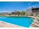 Inviting community pool with surrounding lounge chairs at 8055 E Thomas Rd # E117, Scottsdale, AZ 85251