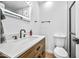 Modern bathroom with wood vanity, white sink, and walk-in shower at 8055 E Thomas Rd # E117, Scottsdale, AZ 85251