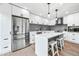 Modern kitchen with white cabinets, gray herringbone backsplash, and stainless steel appliances at 8055 E Thomas Rd # E117, Scottsdale, AZ 85251