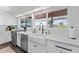 White shaker cabinets, farmhouse sink, and quartz countertops highlight this kitchen at 6875 E Lone Mountain Rd, Scottsdale, AZ 85266