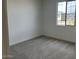 Simple bedroom with grey carpet and large window at 7689 W Tether Trl, Peoria, AZ 85383