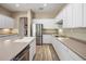 Modern kitchen with white cabinets and stainless steel appliances at 19550 N Grayhawk Dr # 1084, Scottsdale, AZ 85255