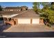 Two-car garage with brick exterior and a covered patio area at 1020 E Caroline Ln, Tempe, AZ 85284