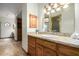 Bathroom with granite countertop, wooden cabinets and a large mirror at 1020 E Caroline Ln, Tempe, AZ 85284