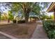 Spacious backyard with mature trees, gazebo, and pathway at 1020 E Caroline Ln, Tempe, AZ 85284