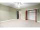 Bright bedroom with double doors leading to closet at 1020 E Caroline Ln, Tempe, AZ 85284