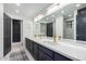 Modern bathroom with double vanity, quartz countertop and gold fixtures at 1020 E Caroline Ln, Tempe, AZ 85284