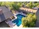 Large backyard pool with a diving board and covered patio at 1020 E Caroline Ln, Tempe, AZ 85284