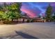 Brick home with large backyard, three-car garage, and gated entry at 1020 E Caroline Ln, Tempe, AZ 85284