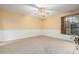 Bright bedroom with ceiling fan and window with wooden shutters at 1020 E Caroline Ln, Tempe, AZ 85284