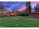 Brick house with landscaped lawn, at dusk at 1020 E Caroline Ln, Tempe, AZ 85284