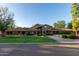 Brick home with large green lawn and mature trees at 1020 E Caroline Ln, Tempe, AZ 85284