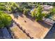 Large empty lot with a brick wall and mature trees at 1020 E Caroline Ln, Tempe, AZ 85284