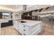 Open concept kitchen with large island, brick fireplace, and high ceilings at 1020 E Caroline Ln, Tempe, AZ 85284