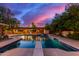Stunning pool at dusk, complete with diving board and a slide at 1020 E Caroline Ln, Tempe, AZ 85284