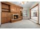 Cozy Gathering room featuring a fireplace and built-in wooden shelving at 1020 E Caroline Ln, Tempe, AZ 85284