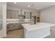 Modern kitchen with gray cabinets, quartz countertops, and stainless steel appliances at 23104 E Carriage Way, Queen Creek, AZ 85142