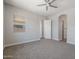 Spacious bedroom with carpet flooring and access to hallway at 23104 E Carriage Way, Queen Creek, AZ 85142