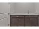 Laundry room with dark cabinets and a utility sink at 19749 S 231 St. Way, Queen Creek, AZ 85142