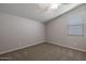 Empty bedroom with carpeted floor, window with blinds, and ceiling fan at 19749 S 231 St. Way, Queen Creek, AZ 85142